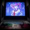 black flat screen tv turned on showing woman in blue dress retro gaming setup, japanese game interface