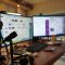 3 AI Video Creation Tools for Faceless YouTube Automation Channels a desk with two monitors and a microphone white label dashboard, agency tools, seo reporting