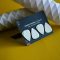a pair of white guitar picks sitting on top of a yellow table gift card, customization, WooCommerce store
