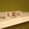 a wooden block that says seo on it search bar, keywords, internet search