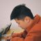 man in orange hoodie using smartphone ai ab testing concept, multivariate testing, experiment analysis