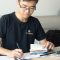 man writing on paper seo analysis, keyword ranking, backlink building