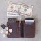 10 us dollar bill beside black leather wallet and coins college student budget, personal finance, backpack