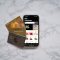 a cellphone lying on the snow apple pay screen, iPhone wallet app, select payment card