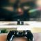 dept of field photography of black Sony PS4 DualShock 4 controller on grey cloth game error screen, server connection, video game issue