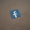 a blue and white facebook logo on a brown surface facebook suggestions, people you may know, social media feed