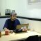 a man sitting at a table with a laptop startup team office brainstorming laptops