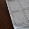 white paper document on brown wooden table invoicing dashboard, tax form, compliance software