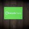 a green recycle here sign on a wooden wall circle logo green recycling renewables