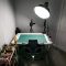 a room with a table and a light in it youtube creator studio setup, ring light camera, person recording video